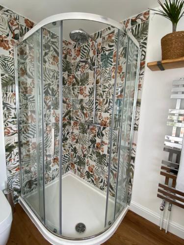 a shower with a glass enclosure in a bathroom at Marshpools Bed & Breakfast - Licensed near Weobley village in Weobley