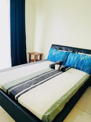 a bed with a teddy bear sitting on it at Wind Suites Tagaytay at SMDC in Tagaytay