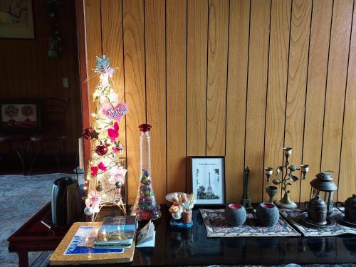 a table with a christmas tree in a room at Grandmother's Vegetable garden in Anseong