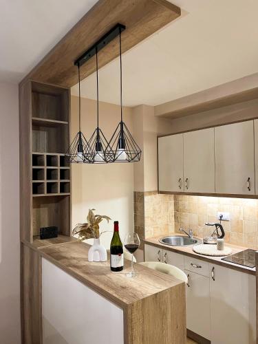 a kitchen with a bottle of wine on a counter at Borski Luxury Apartments in Zlatibor