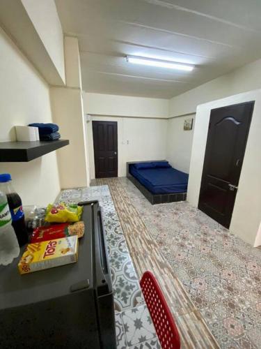 a room with a bed and a table and a chair at Ratanawong Place 801 in Bangkok