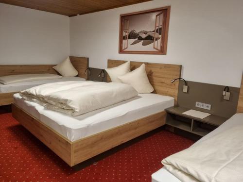 a room with two beds in a room at Haus Wildbach in Kappl