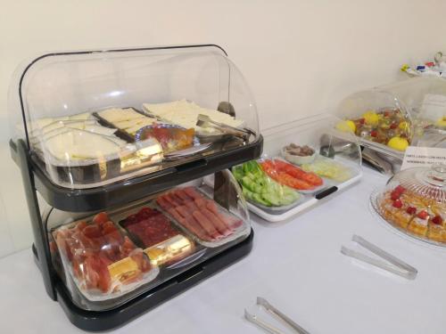 a refrigerator filled with different types of food at La Luna Blanca in Torremolinos