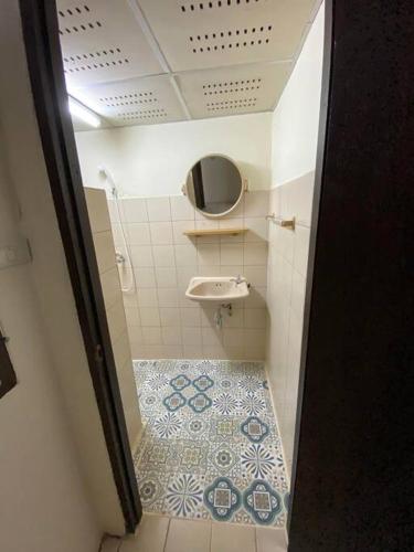 a small bathroom with a sink and a toilet at Ratanawong Place 334 in Bangkok