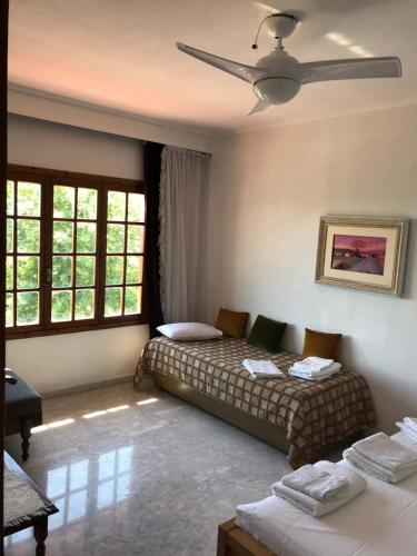 a bedroom with two beds and a ceiling fan at great first floor appartment with view in Nea Kallikrateia