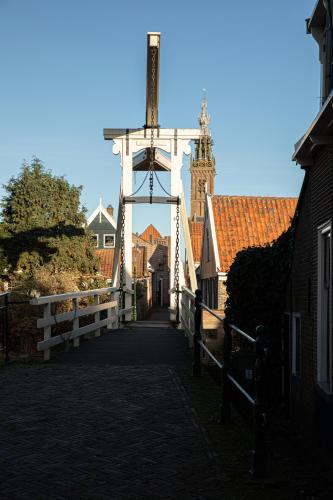 a bridge over a street with a building in the background at Grand Monumental Residence Edam in Edam