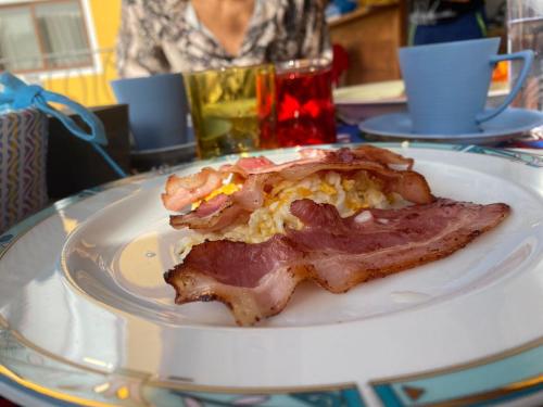 a plate with a piece of breakfast food on it at Orietta Residencial in Mindelo