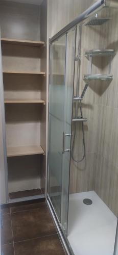 a shower with a glass door in a bathroom at PC CHICLANA, PARKING, WIFI, aire, confort in Chiclana de la Frontera