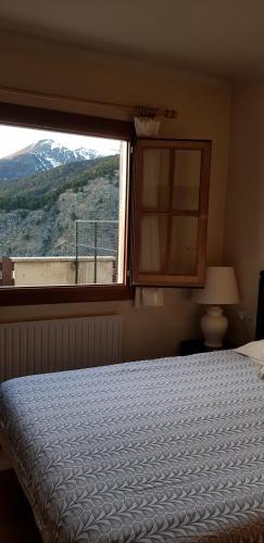 a bedroom with a bed and a large window at Soldeu Paradis Soldeu in Soldeu