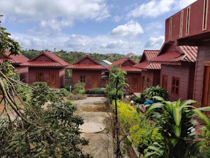 a row of houses with red roofs in a village at Phanyro Motel in Sen Monorom