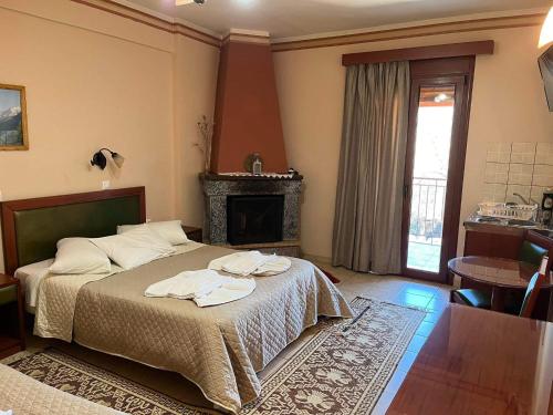 a bedroom with a bed and a fireplace at To Spiti tis Irinis in Vitina