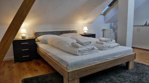a bedroom with a bed with white sheets and pillows at Wohlfühlen in der Bauhausstadt Dessau in Dessau