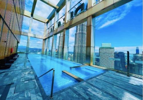 a swimming pool in the middle of a building at Tropicana The Residences KLCC By Luxury Suites in Kuala Lumpur