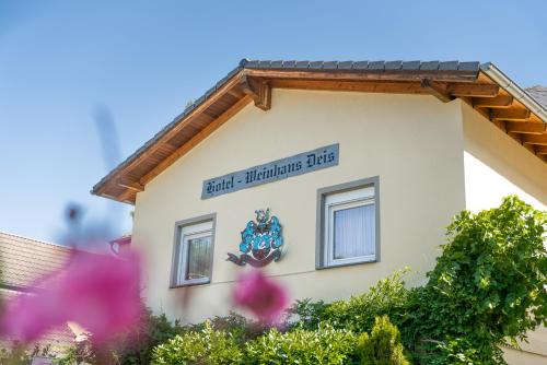 a building with a sign on the side of it at Hotel Deis in Senheim