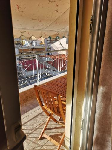 a wooden bench sitting on top of a balcony at Serres Kavafi 7 city center , FREE PARKING in Serres