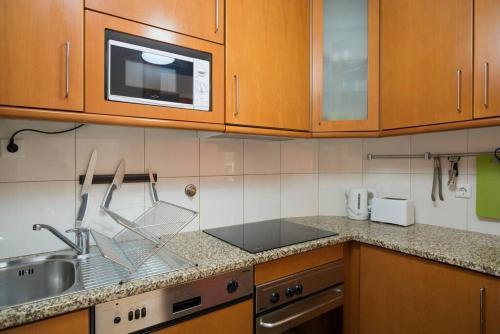 a kitchen with a sink and a microwave at Dunas Flat in Lavra