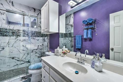 a purple bathroom with a sink and a toilet at Spacious Ranch in Argyle with Private Pool & Spa 