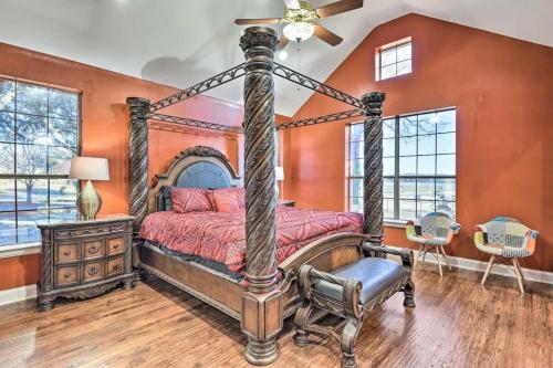 an orange bedroom with a bed and a ceiling fan at Spacious Ranch in Argyle with Private Pool & Spa 