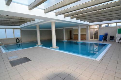 a large swimming pool in a building at Dunas Flat in Lavra