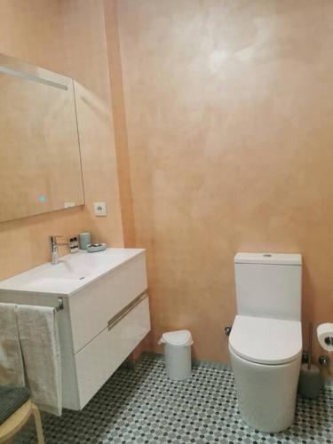 a bathroom with a white toilet and a sink at Dunas Flat in Lavra