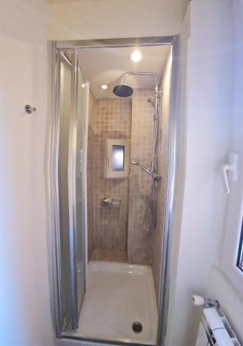 a shower with a glass door in a bathroom at Julia nel cuore di Trastevere in Rome
