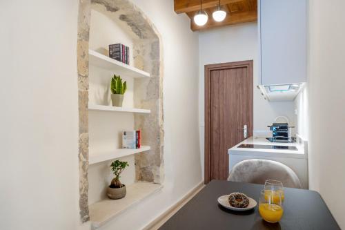 a small kitchen with a table and a sink at Casa Del Balsamo in Rethymno Town