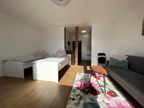 a living room with a bed and a couch at Wohnung Magdalena in Feldkirchen in Kärnten