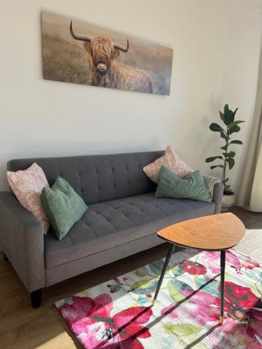 a living room with a couch and a picture of a bull at Wohnung Magdalena in Feldkirchen in Kärnten