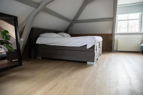 a bedroom with a bed in a attic at Grand Monumental Residence Edam in Edam