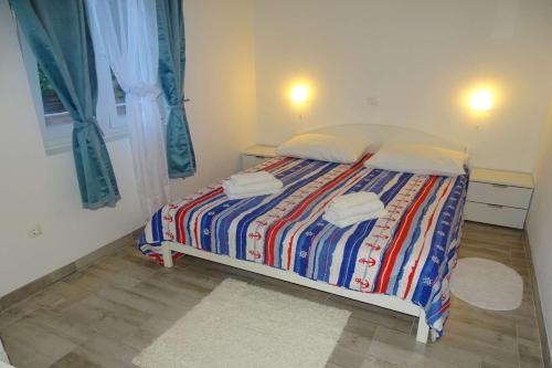 a bedroom with a bed with two towels on it at Apartment Seaview, Rtina in Rtina