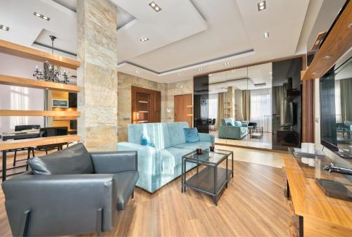 a living room with a couch and a table at Dom & House - Apartment Neptun Park Premium in Jelitkowo