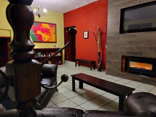 a living room with a couch and a fireplace at Casa Cantares in Guanajuato