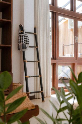 a ladder leaning against a wall next to a window at Surf Station in Ahangama