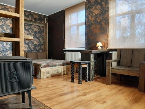 a room with a bed and a table and a window at Champêtre Park View Apartments in Rīga