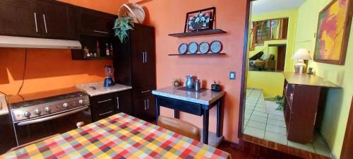 a kitchen with a table and a sink in it at Casa Cantares in Guanajuato