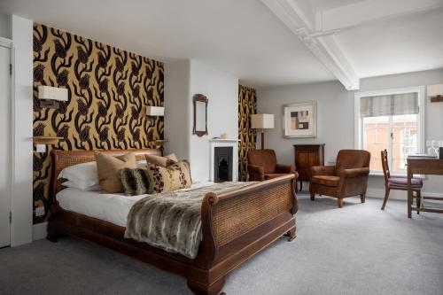 a bedroom with a large bed and a living room at St Johns House Lichfield in Lichfield