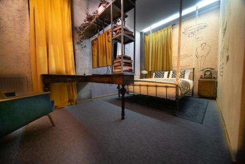 a room with a table and a bed in it at Ati Ambavi Botique Hotel Gudauri in Gudauri