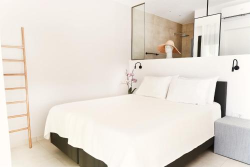 a bedroom with a white bed and a mirror at Villa Mouria private villa just 200m from the sea in Pogoniá