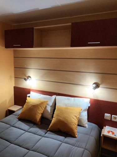 a bedroom with a bed with two pillows on it at Slow M'Ocean Villa in Pataias