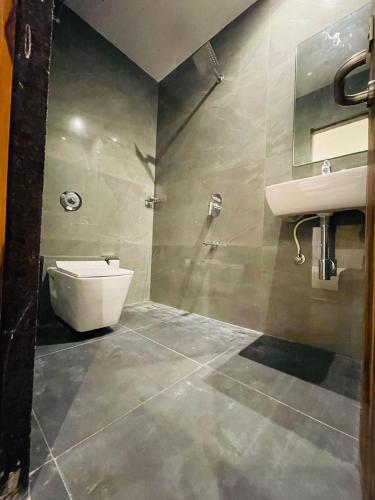 a bathroom with a sink and a toilet at Hotel Hilton Suites in Mumbai