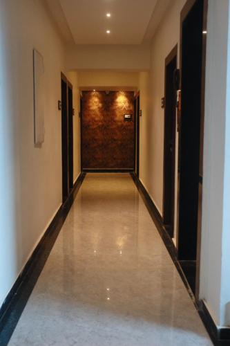 a hallway of a building with a long corridor at Hotel Candor Amigo Airoli Mind Space in Navi Mumbai