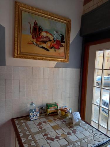 a bathroom with a painting on the wall and a counter at D'ALTRITEMPI-Elegance in Cianciana. in Cianciana
