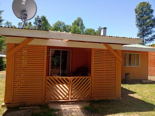 a large wooden shed with a porch at Cabañas Marisol in Pucón