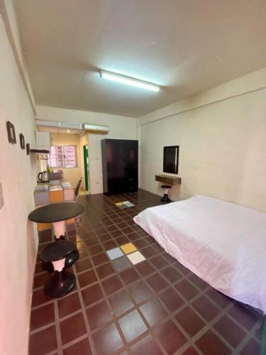 a room with a bed and a table in it at Ratanawong Place 516 in Bangkok