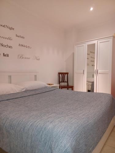 a bedroom with a bed and a sign on the wall at Casamassimi apartment in Bari