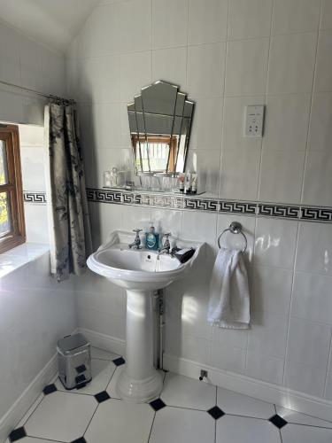 a white bathroom with a sink and a mirror at Catesby Barn Farm B&B in Daventry