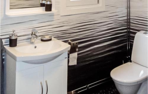 a bathroom with a sink and a toilet at 2 Bedroom Cozy Home In Järnforsen in Järnforsen