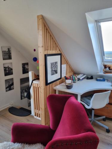 an attic office with a desk and a chair at Marsvinslund bed and breakfast in Viborg