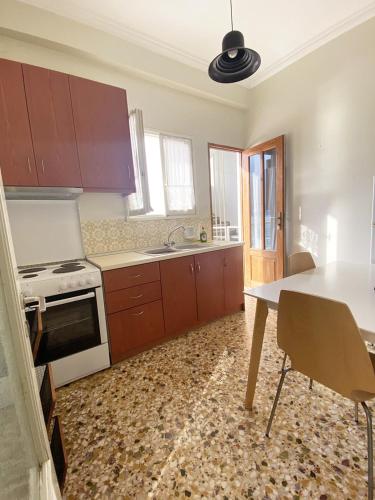 a kitchen with a table and a stove top oven at Thassa Beach Apartment No4 in Leonidion