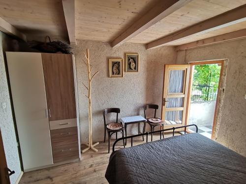 a bedroom with a bed and a table and chairs at Apartmani Purić in Malinska